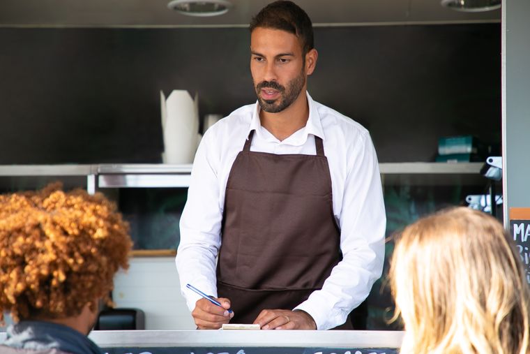 Restaurant worker recording an order